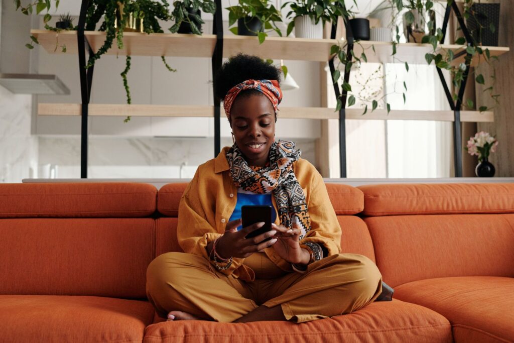 Customer smiling as she reads a WhatsApp message from a business