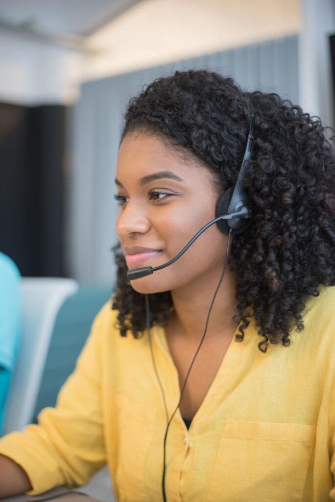 Support agent answering customer chats with a headset